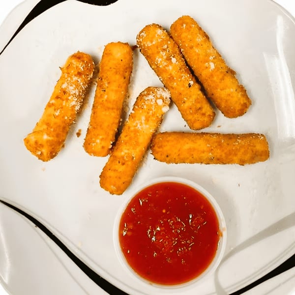 Golden-brown mozzarella sticks, sprinkled with Parmesan cheese, served with a side of marinara sauce.