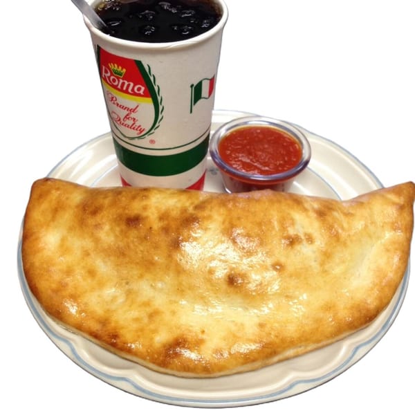 Golden-brown calzone with a side of marinara sauce and a Roma brand soda on a plate.