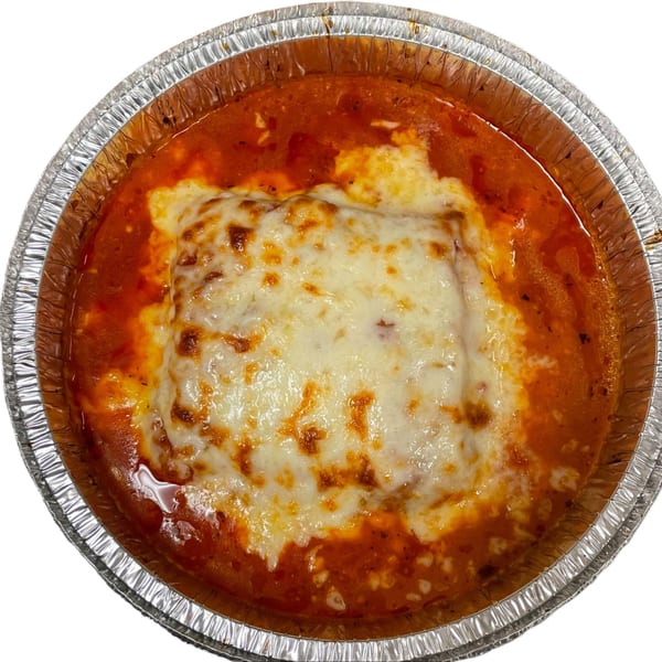 Niki's Pizza baked lasagna with melted cheese and red sauce in a foil container.